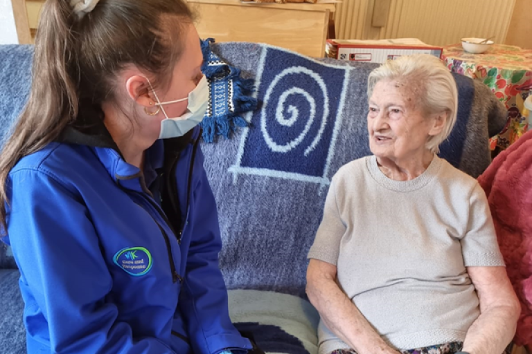 A member of the Care and Response team on a visit with a local resident
