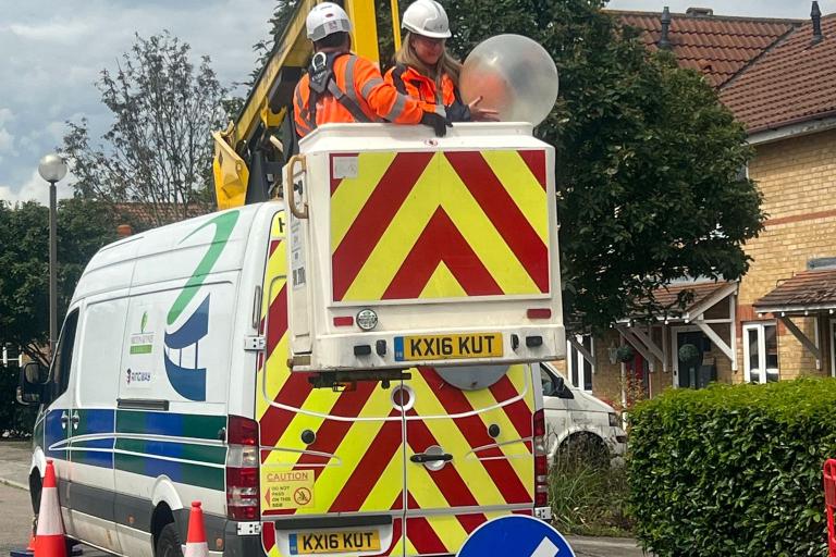 Engineer upgrading old streetlight to an LED lantern