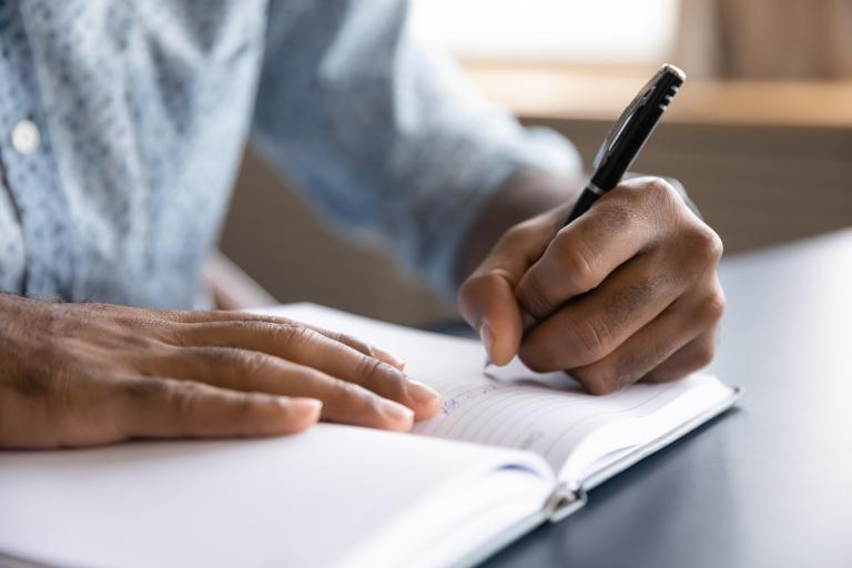 Man writing in a book