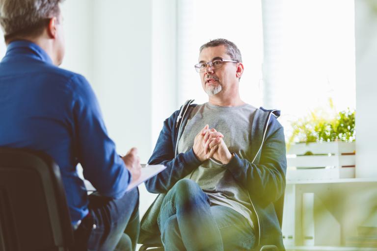 Man speaking to health professional