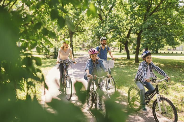 A family cycling together in a park