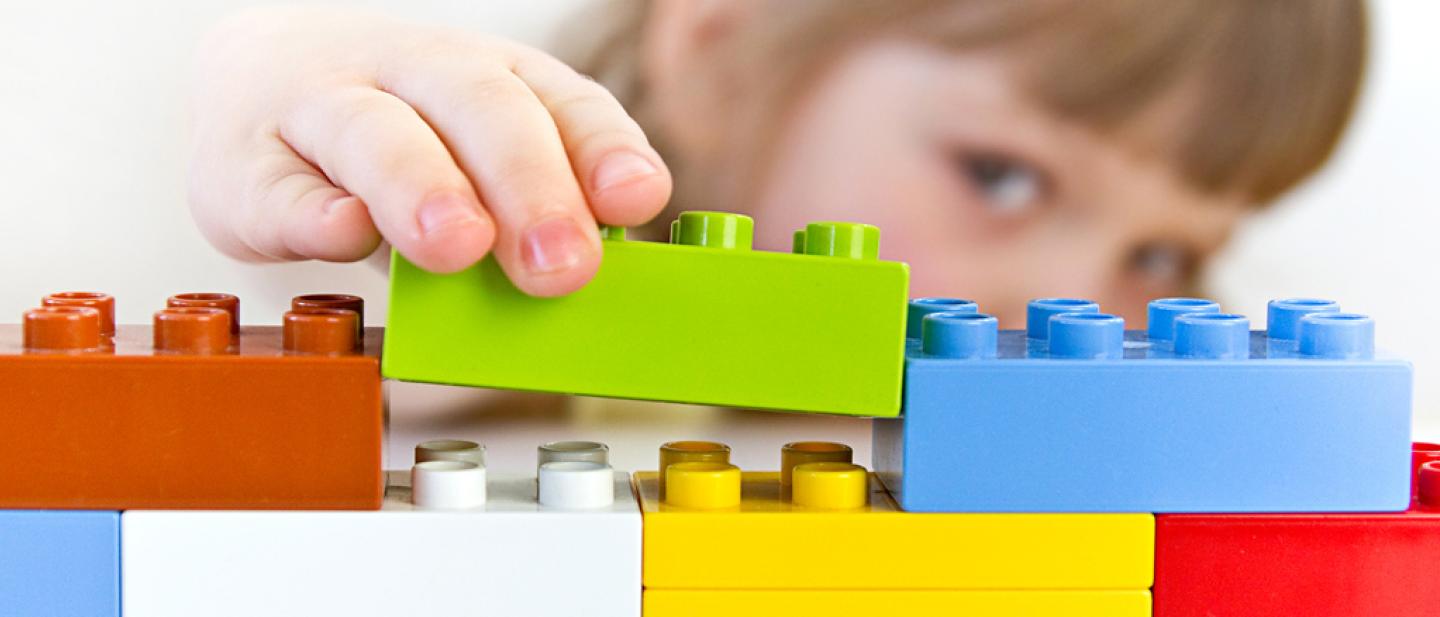 Girl building with Duplo bricks