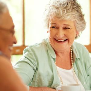 Two mature ladies having a chat and smiling
